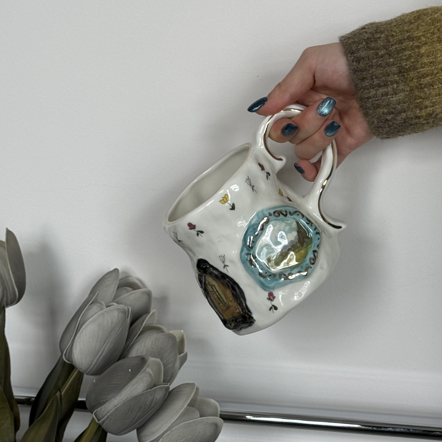 Handmade ceramic mug with floral designs